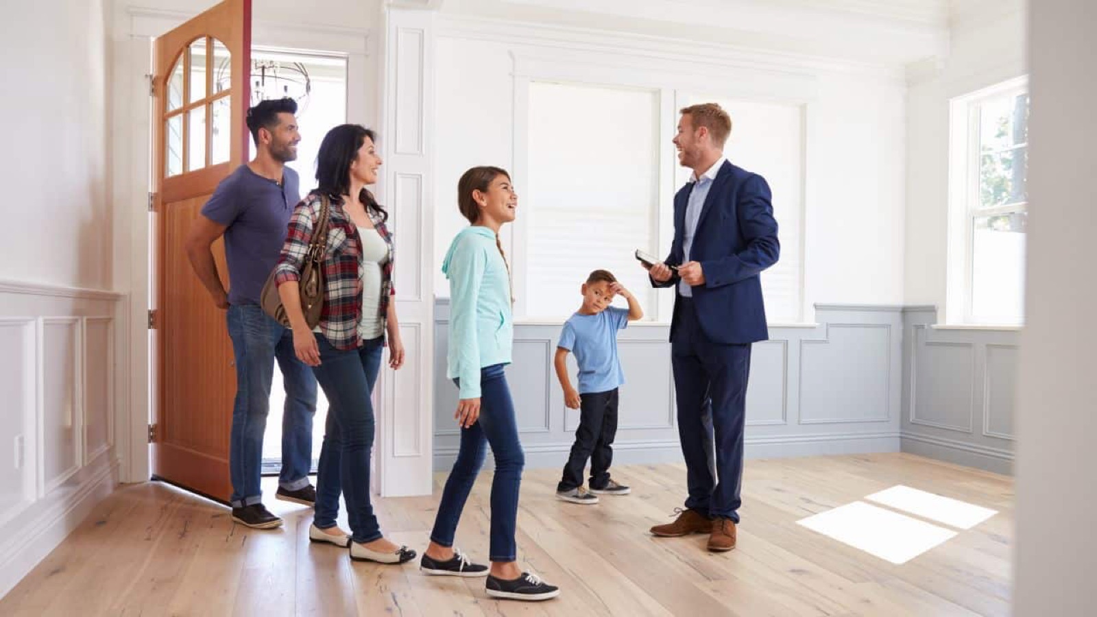 Family being shown around a home by a Clarke Properties agent